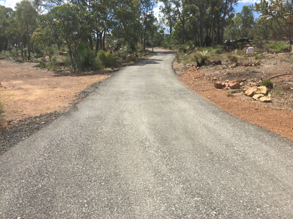 This is a photo of a hot spray & seal bitumen driveway which is in the process of being installed by Wagga Wagga Road Tech